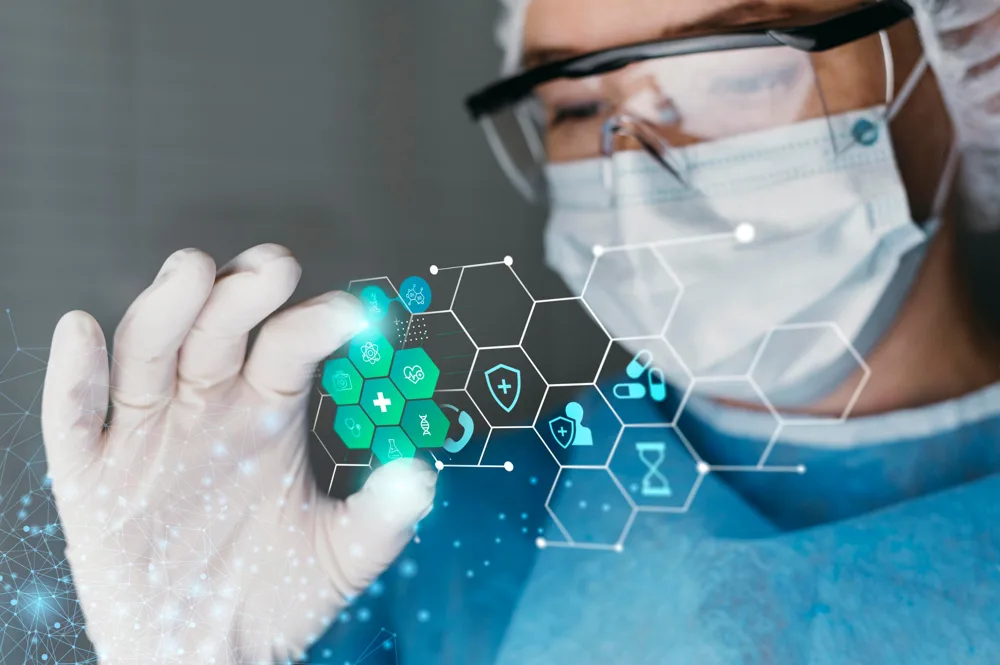 Doctor in mask and goggles holding a glowing medical icon display